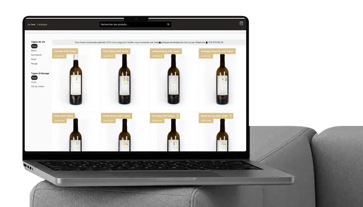 Philippe Darioli wine catalogue on a MacBook on a sofa.